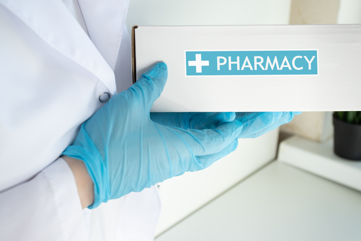 online, pills shipping, pharmacist holding a box with medical order